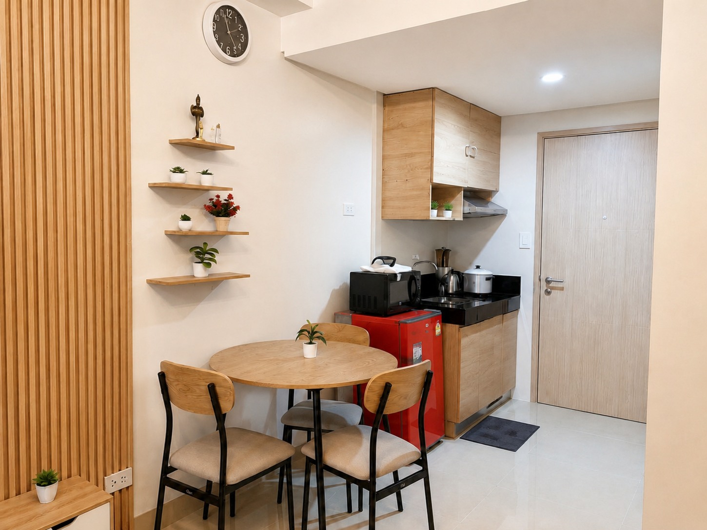 Round dining table for four beside Moon Haven's compact kitchenette