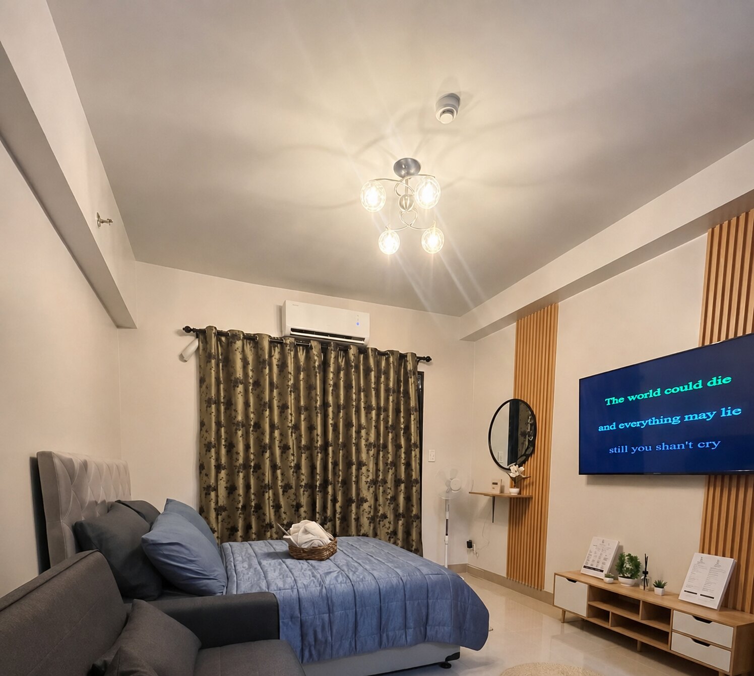 Moon Haven sleeping area with bed, air conditioning, curtains, and wall-mounted television